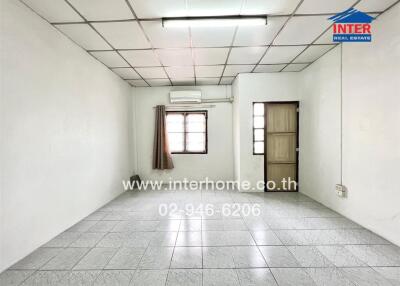 Empty living space with tiled floor and single window