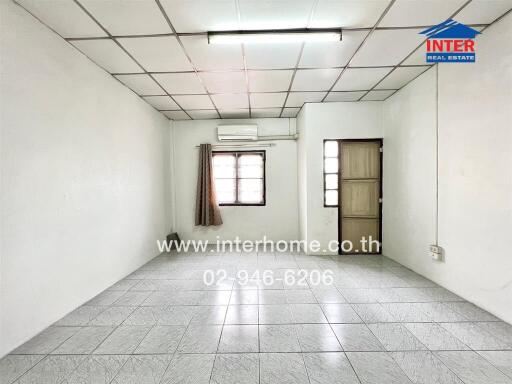 Empty living space with tiled floor and single window