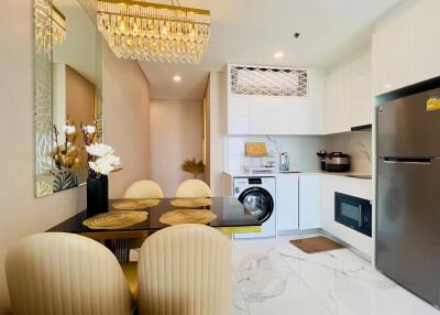 Modern kitchen and dining area with appliances and chandelier
