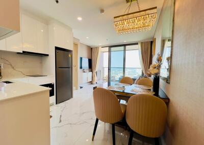 Contemporary kitchen and adjoining living space with dining table and chairs