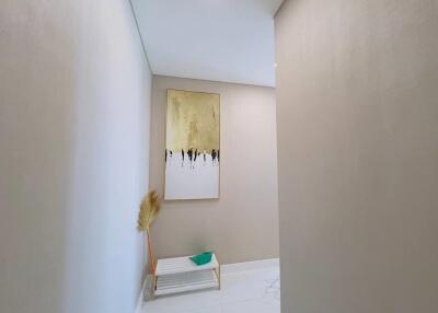 Minimalist hallway with artwork and small bench