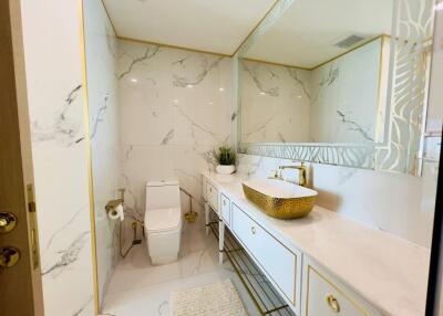 Elegant modern bathroom with marble tiles and gold accents