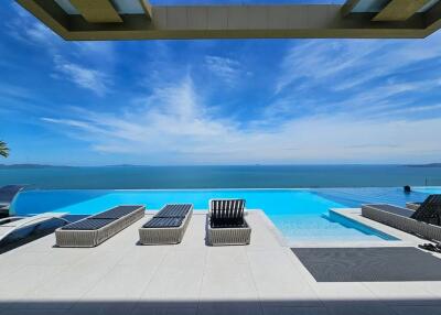 Luxury infinity pool overlooking the ocean under a clear blue sky