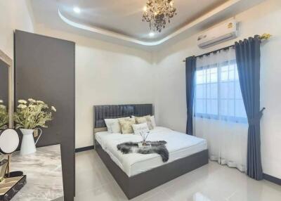 Elegant bedroom with chandelier and modern decor