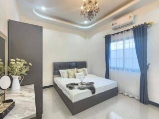 Elegant bedroom with chandelier and modern decor