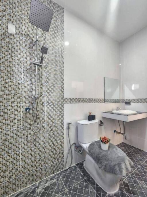 Modern bathroom with shower, toilet, and sink