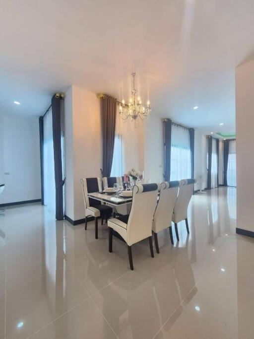 Modern dining room with chandelier and large windows