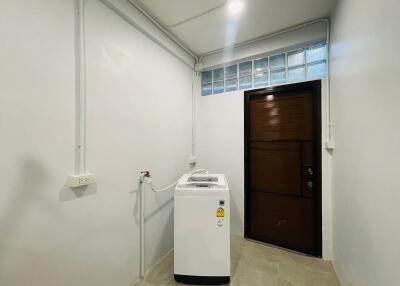 Laundry room with washing machine and door