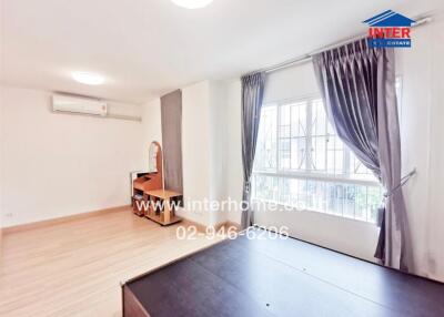 Bright bedroom with wooden furniture and large window