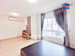 Bright bedroom with wooden furniture and large window