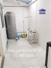 Utility room with water tank and tools