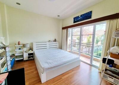 Spacious bedroom with a large window and double bed