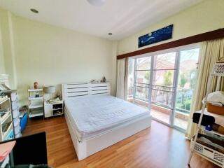 Spacious bedroom with a large window and double bed