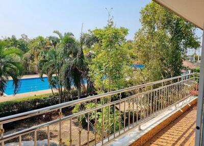 Balcony with a view of pool and greenery
