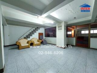 Spacious living area with staircase and seating