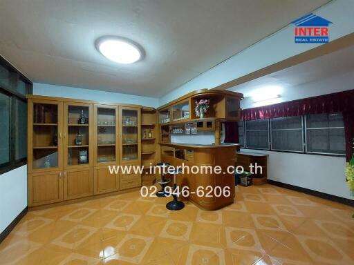 Spacious kitchen with wooden cabinets and a bar counter
