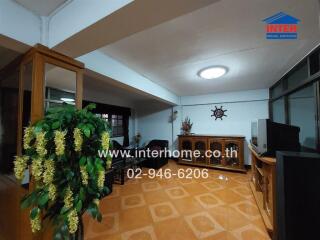 Spacious living room with tiled floor and wooden furniture