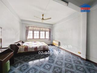 Bedroom with bed, windows, and ceiling fan