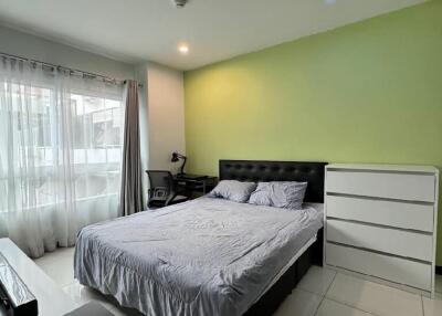 Modern bedroom with green accent wall