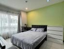 Modern bedroom with green accent wall