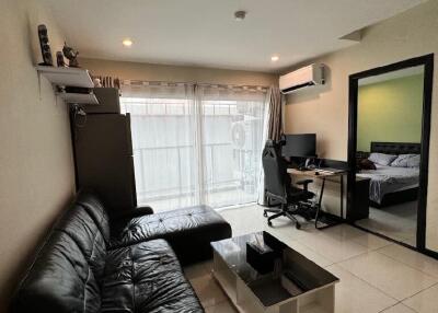 Modern living room with leather sofa and workspace