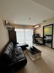 Modern living room with leather sofa and workspace