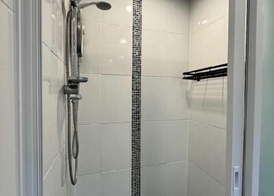 Modern bathroom shower area with tiled walls and overhead shower
