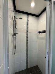 Modern bathroom shower area with tiled walls and overhead shower