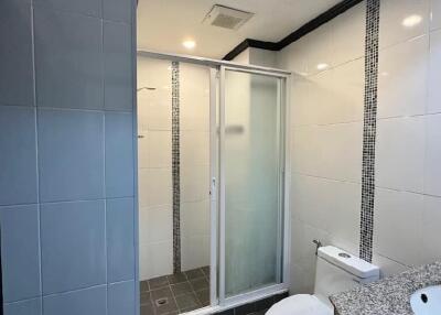 Modern bathroom with shower and granite countertop