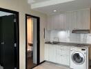 Modern kitchen with washer and adjacent bathroom