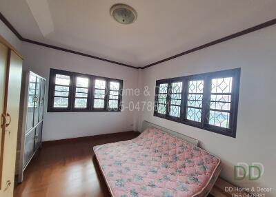 Bedroom with large windows and a mattress on the floor