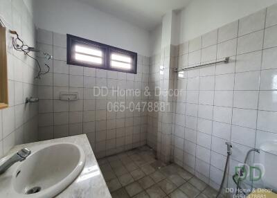 Bathroom with tiled walls and window