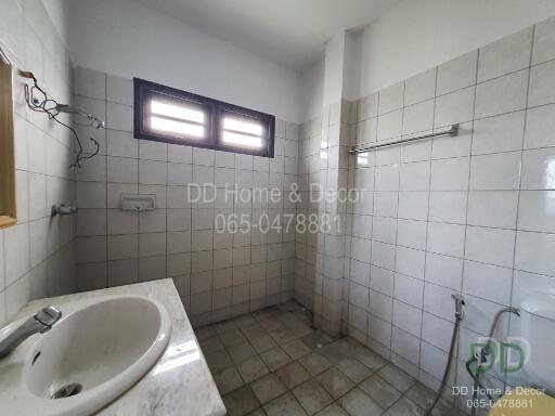 Bathroom with tiled walls and window