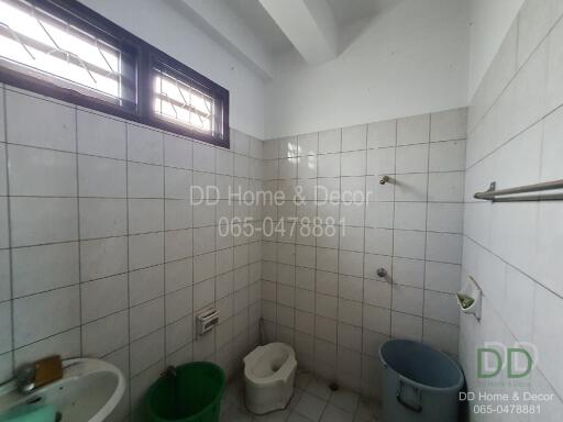 Bathroom with tiled walls and various fixtures