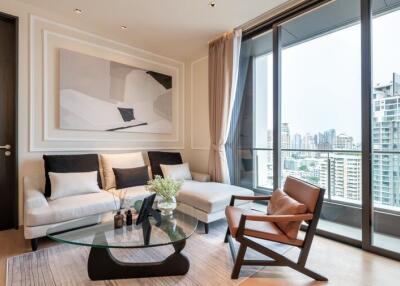 Modern living room with city view, large windows, and contemporary furniture