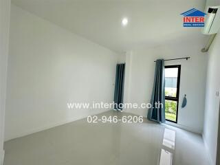 Empty bedroom with glossy tiled floors, curtains, and an air conditioner