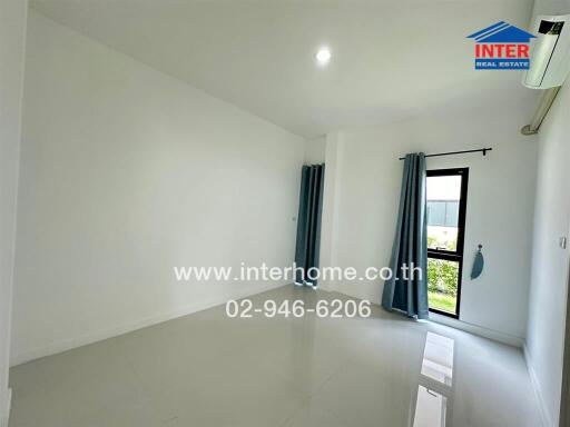 Empty bedroom with glossy tiled floors, curtains, and an air conditioner