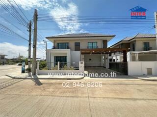 Two-story house with driveway and garden