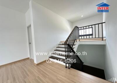 Staircase area with wooden flooring