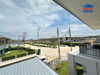 View of a residential area from a balcony with nearby houses and ongoing construction