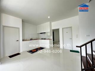 Bright modern kitchen with white cabinets and sleek flooring