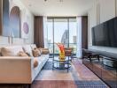 Modern living room with large television, sofa, coffee tables, and city view through large windows