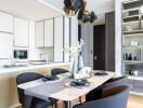 Modern dining area with black padded chairs and dining table, adjacent to contemporary kitchen