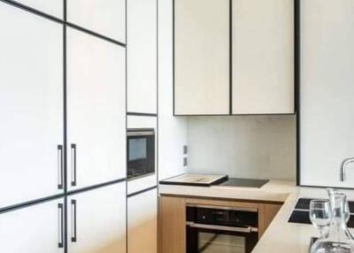 Modern kitchen with white cabinetry and built-in appliances