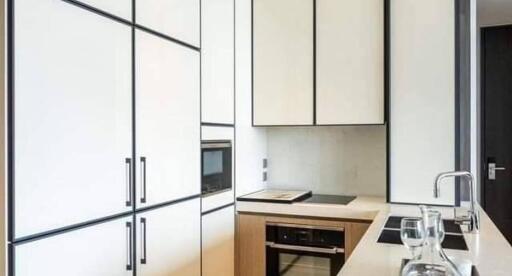 Modern kitchen with white cabinetry and built-in appliances