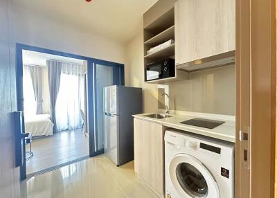 Modern kitchen with appliances next to a bright bedroom