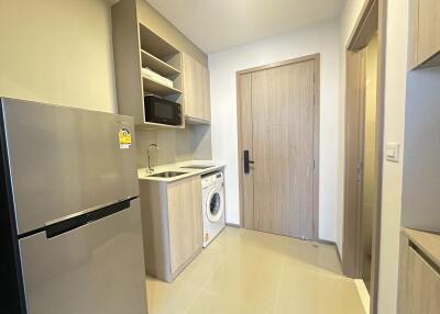 Modern kitchen with fridge and washing machine