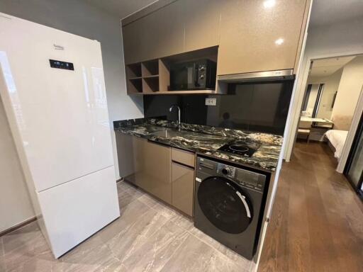 Modern kitchen with appliances and marble countertop