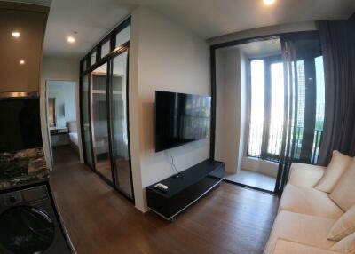 Modern apartment living area with TV and balcony access