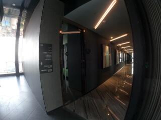 Modern hallway with glossy floor tiles and overhead lighting